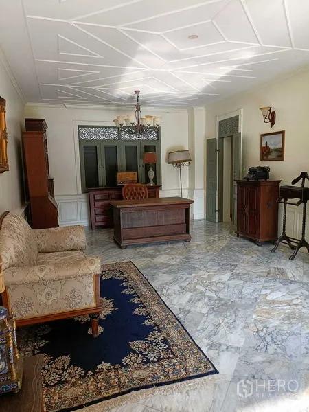 Detached House for rent or sale in Krathum Baen, Samut Sakhon - Home office with marble floor, vintage wooden desk and sofa.