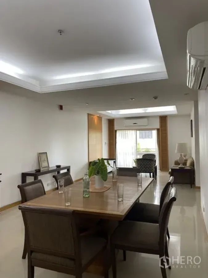 Condominium for rent - Bright open-plan living and dining room with recessed lighting, air conditioning and balcony access.