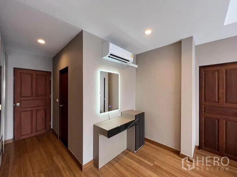Detached House for sale in Mueang Pathum Thani, Pathum Thani - Dressing nook with LED vanity mirror, air conditioner and wooden doors