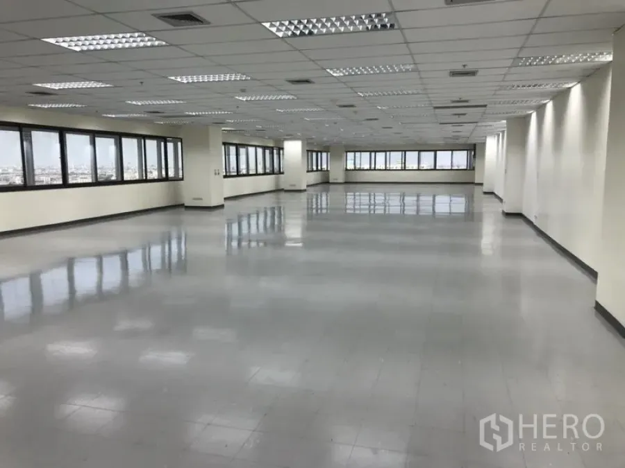 Office Space for rent in Bang Na, Bangkok - Open office area with rows of large windows, tiled floors, air-conditioning vents and bright LED lights in Bangkok.