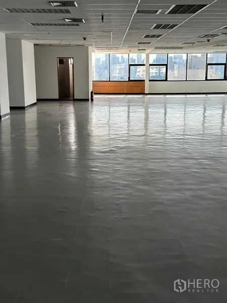 Office Space for rent in Bangkok - Open office zone with long rows of windows for daylight and a small private room at the rear.