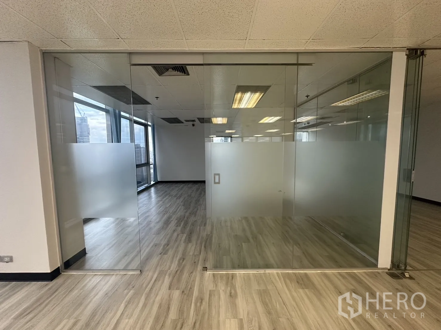 Office Space for rent - Frosted glass sliding doors leading to a private meeting room inside the office.