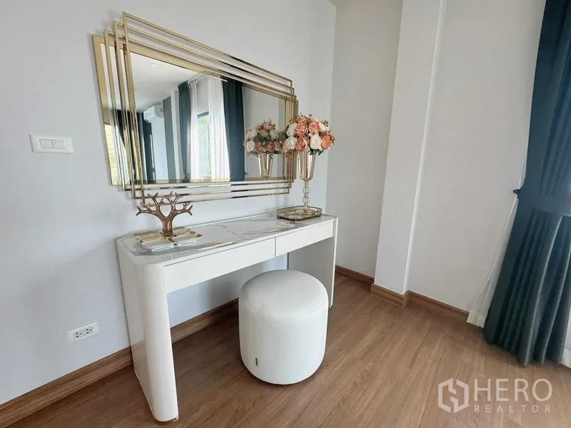 Detached House for rent or sale - Dressing corner with white vanity, large gold-framed mirror and floral decor.
