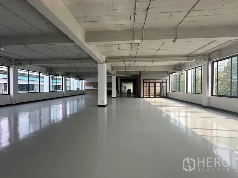 Office Space for rent - Expansive floor plate with dual-aspect windows and glass meeting room entrance.