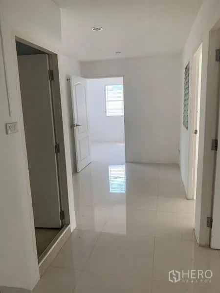 ทาวน์เฮาส์ ให้เช่าในDin Daeng, Bangkok - โถงชั้นล่างสว่างพื้นกระเบื้องเงาและผนังสีขาวในทาวน์เฮ้าส์กรุงเทพฯ