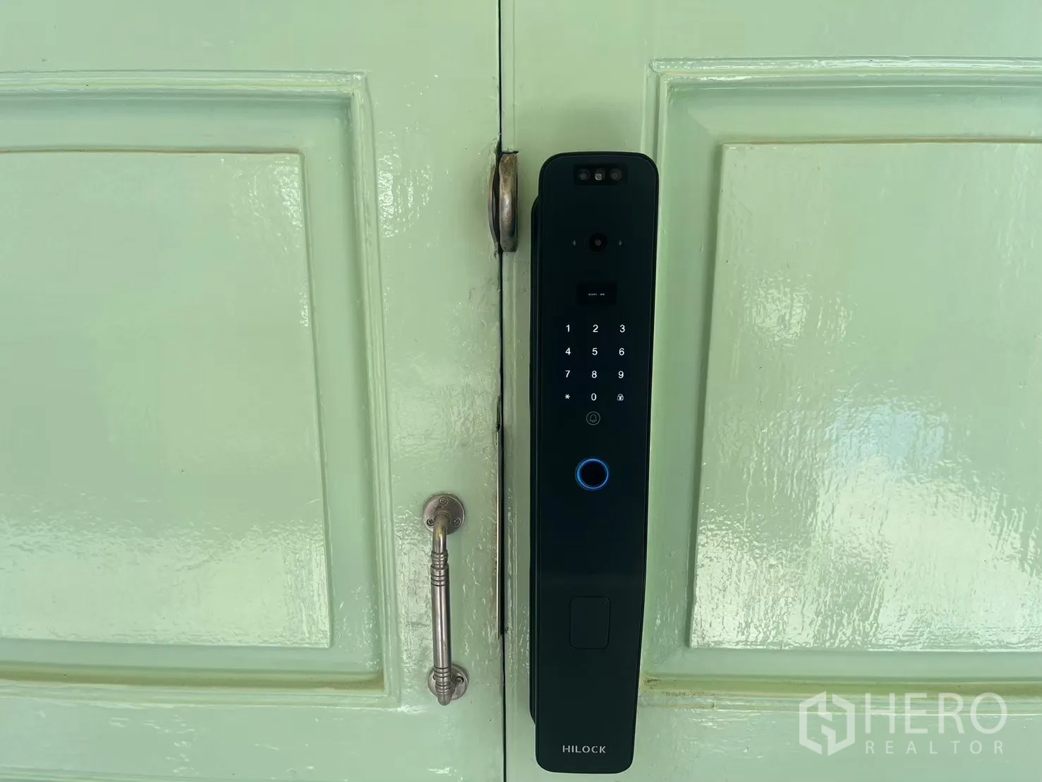 Shophouse for rent in Bang Rak, Bangkok - Smart digital door lock on a mint green wooden door.