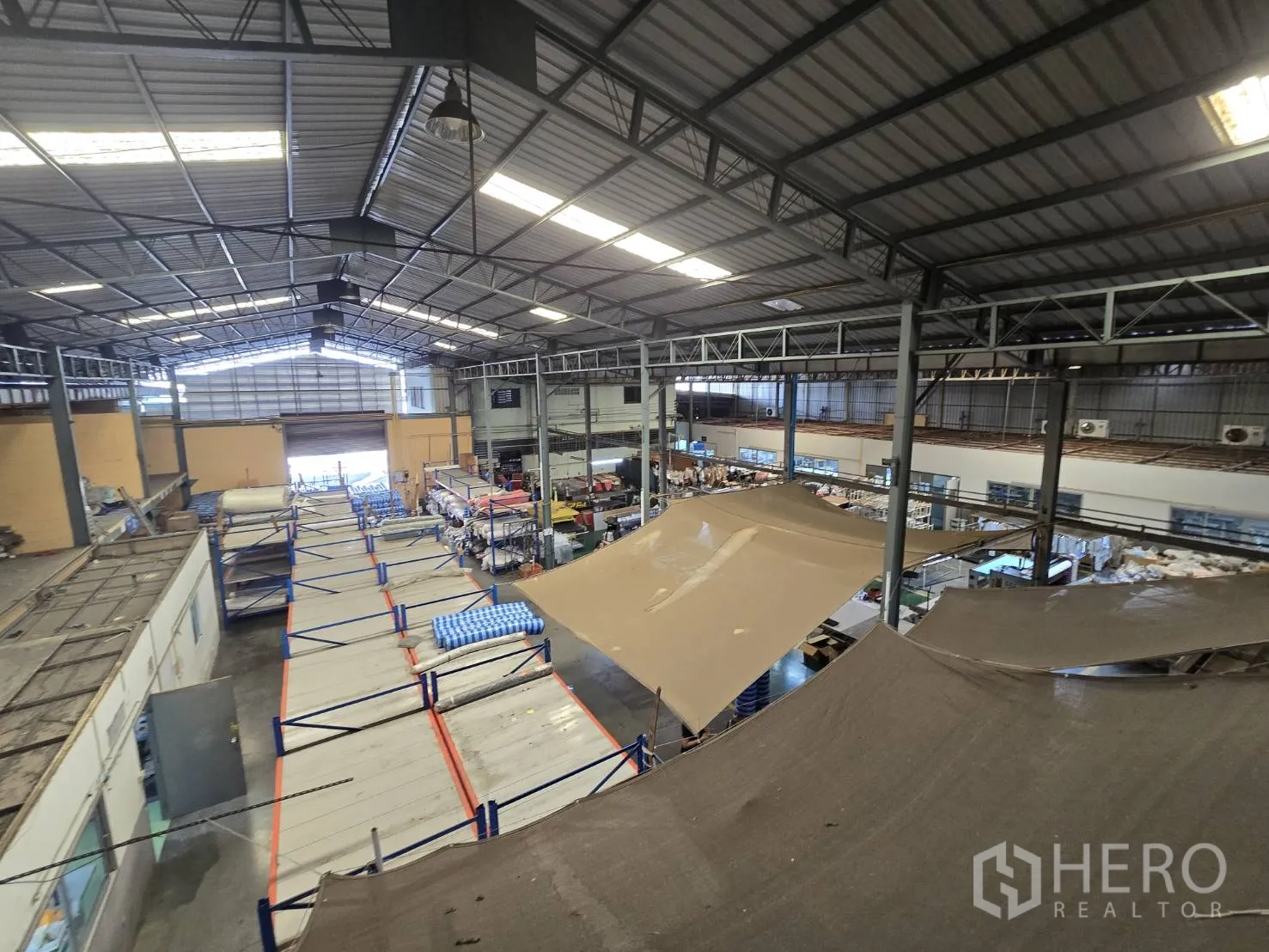 Factory for rent in Sam Phran, Nakhon Pathom - Overhead view of wide warehouse bay leading to a roller shutter door.