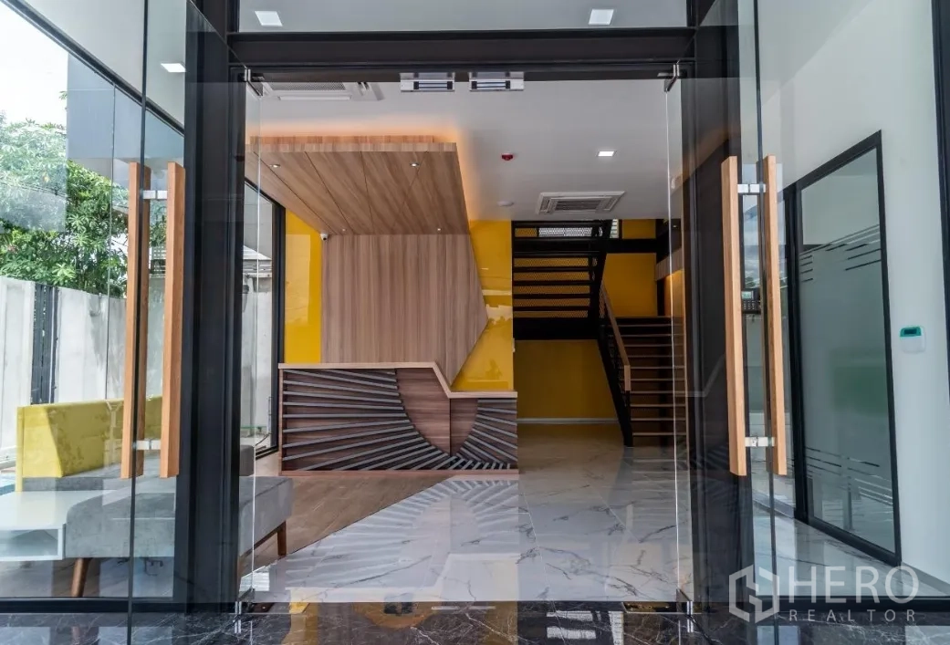 Warehouse for sale in Bang Khen, Bangkok - Main entrance with glass doors opening to reception area and staircase.