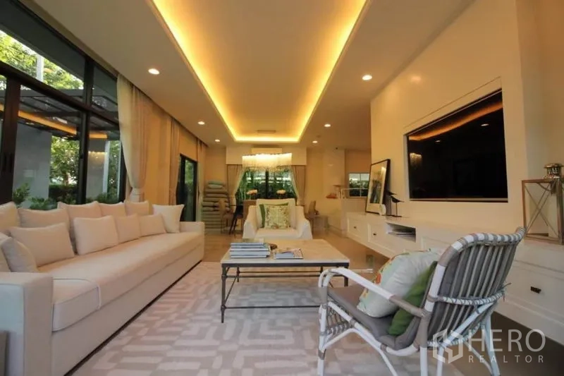 Detached House for rent or sale in Prawet, Bangkok - Long open living space facing the dining zone, recessed ceiling lights, and full-height windows.