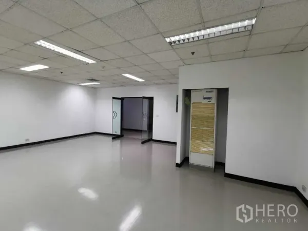 Office Space for rent in Watthana, Bangkok - Spacious workspace with bright lighting, glass entry doors and built-in air-conditioning.