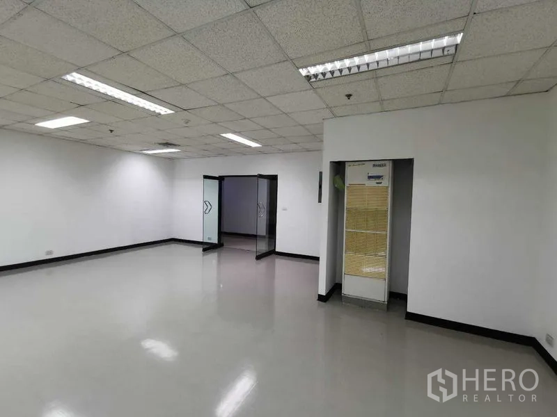Office Space for rent in Watthana, Bangkok - Spacious workspace with bright lighting, glass entry doors and built-in air-conditioning.