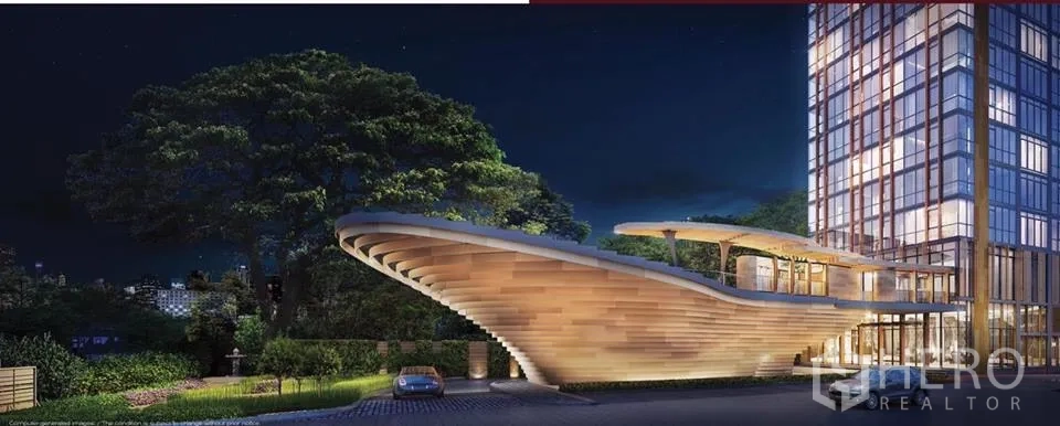 公寓 出售在Watthana, Bangkok - 夜景外观，高层塔楼与弧形门廊平台及景观车道。