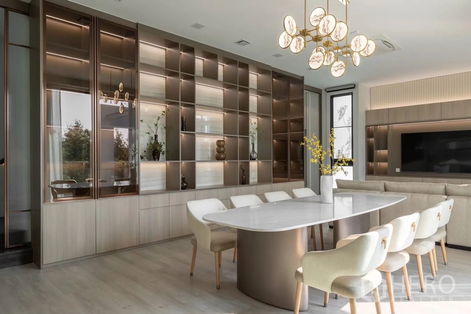 Detached House for rent in Saphan Sung, Bangkok - Elegant dining room with marble-style chandelier and illuminated display cabinetry.