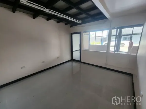 Warehouse for rent in Suan Luang, Bangkok - Bright office room with windows and a glass door looking out to the forecourt.