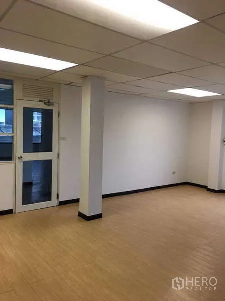 Office Space for rent in Bang Na, Bangkok - Columned office zone with wood-look flooring and recessed lighting.