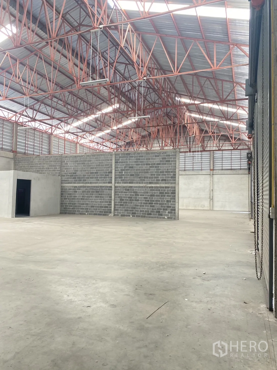 货栈 出租在Khlong Sam Wa, Bangkok - 仓库内部宽敞，高挑红色钢桁架屋顶与天窗，带砌块隔墙。