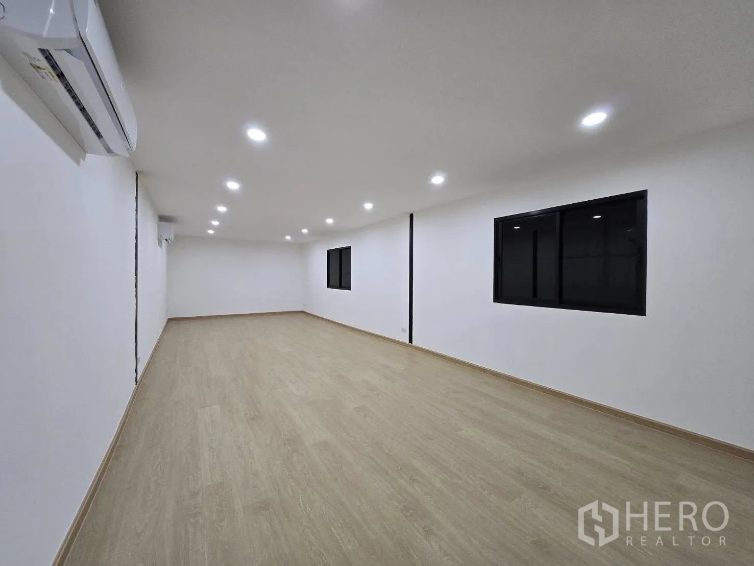 Warehouse for rent - Bright upstairs office room with wood-look flooring, recessed lights and air-conditioning installed.