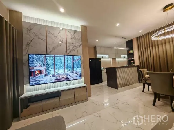 Detached House for rent in Bang Phli, Samut Prakan - Open-plan living area with marble-look floors, a feature TV wall and a stylish breakfast bar.