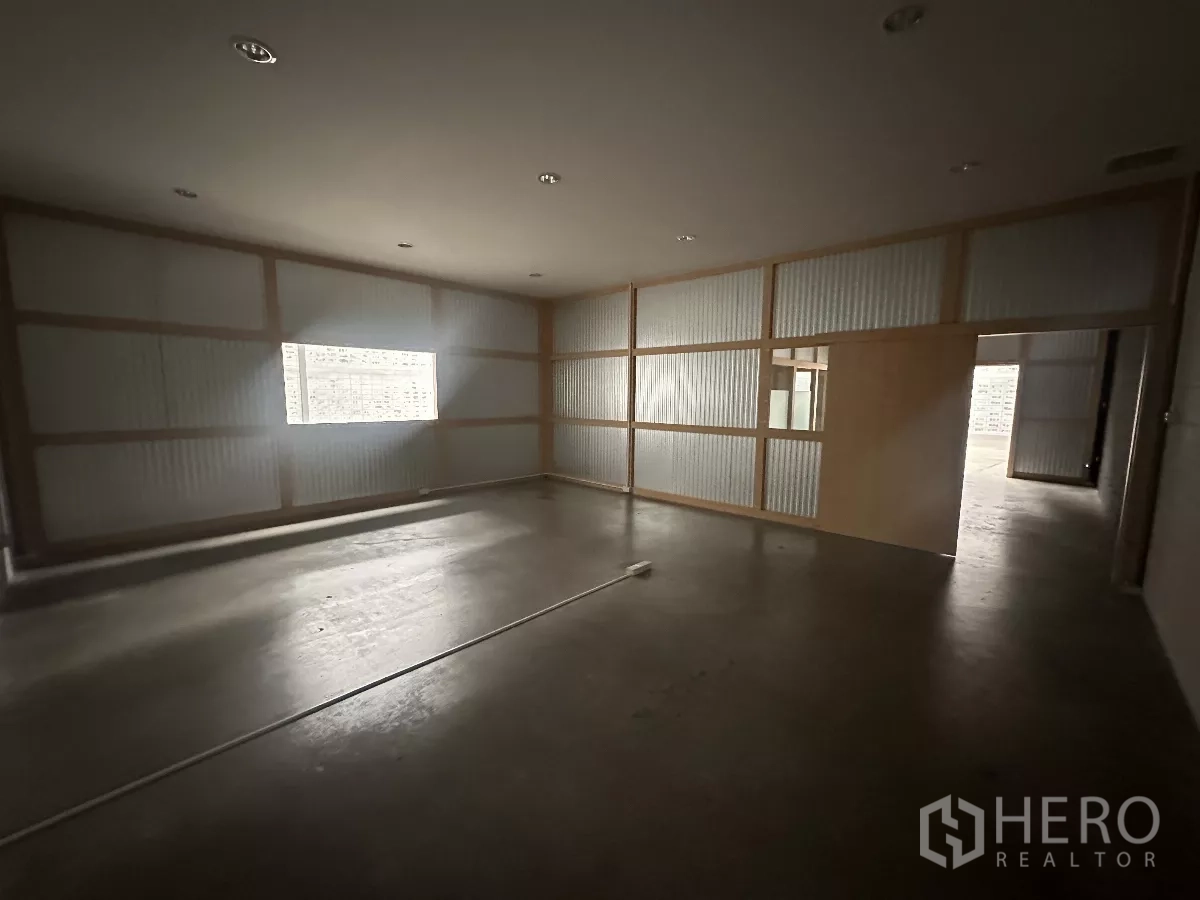 Warehouse for rent in Khlong Toei, Bangkok - Spacious office room with window and sliding door within the warehouse.