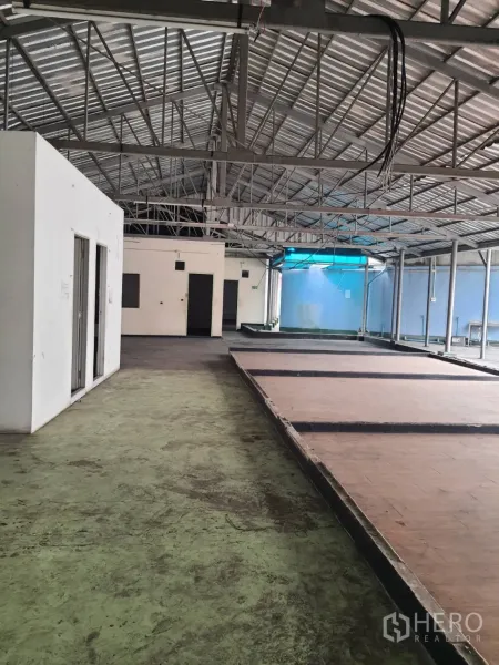 อาคารพาณิชย์ ให้เช่าในKhlong Toei, Bangkok - ภายในตึกแถวแบบโอเพ่นสเปซ หลังคาโครงเหล็กสูง พื้นคอนกรีต พร้อมแท่นยกและห้องบริการ