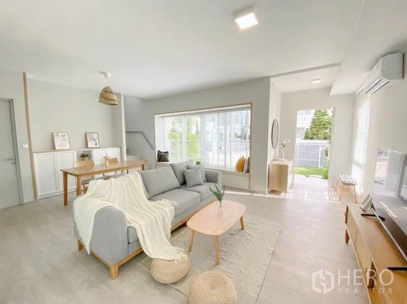 独立式住宅 出租在Prawet, Bangkok - 阳光客厅，飘窗坐榻与通往庭院的入户门