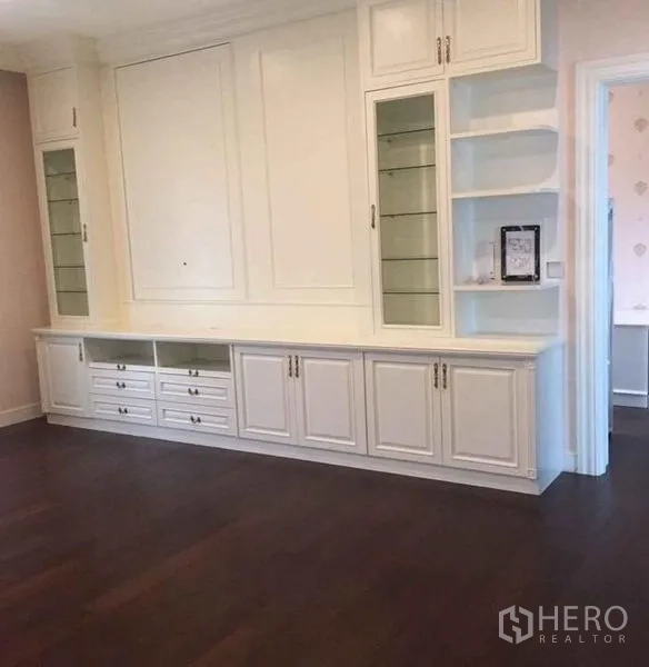 Detached House for rent or sale in Bang Phli, Samut Prakan - Built-in wall cabinetry and shelving unit in a bedroom or study with wood floors.