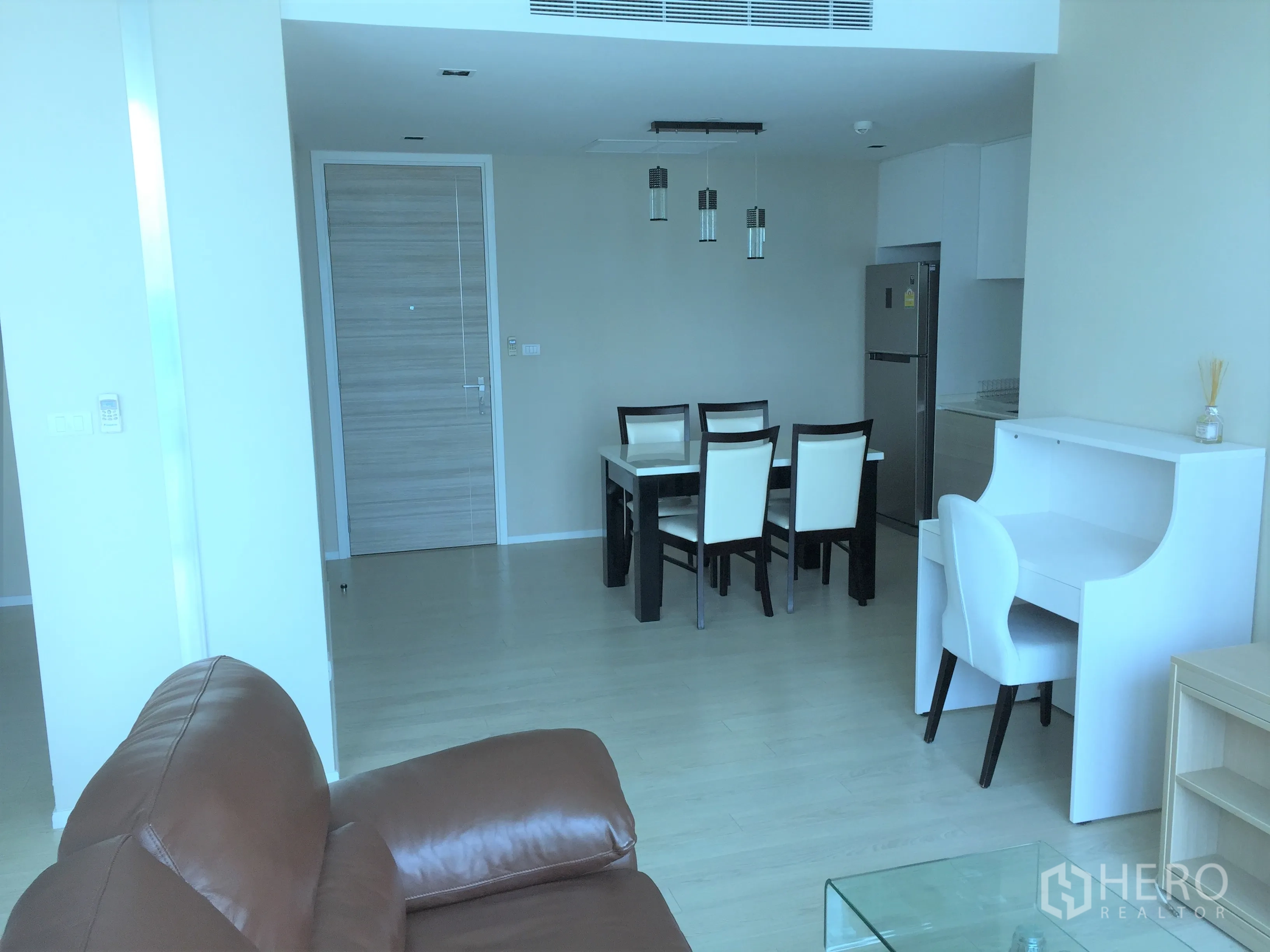 公寓 出租在Watthana, Bangkok - 开放式客餐厅，设书桌、沙发与吊灯。