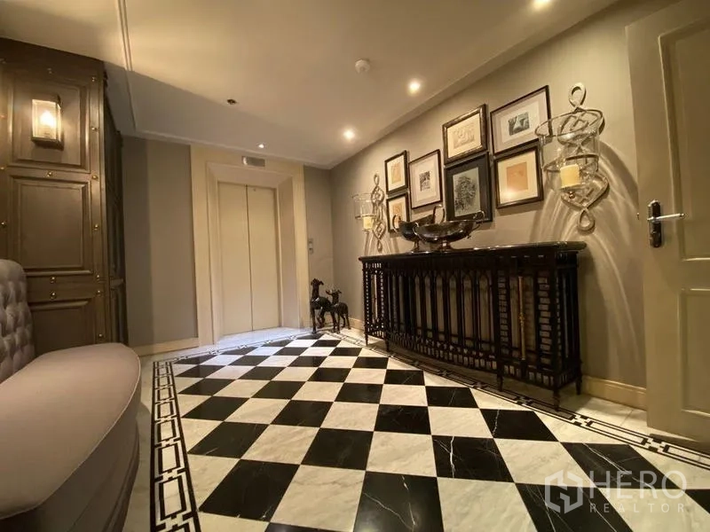Condominium for rent in Khlong San, Bangkok - Private lift lobby with black‑and‑white checkerboard marble floor and framed artwork.