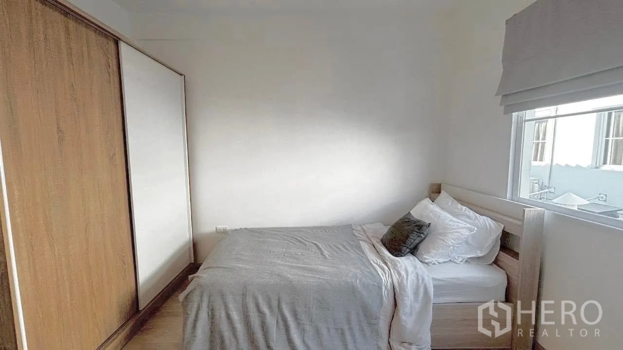 Townhouse for rent in Prawet, Bangkok - Cozy bedroom with double bed, built-in wardrobe and a bright window with blinds.