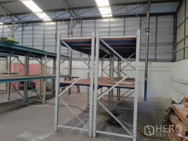 Warehouse for rent in Huai Khwang, Bangkok - Close view of heavy-duty storage shelves inside a well-lit warehouse.