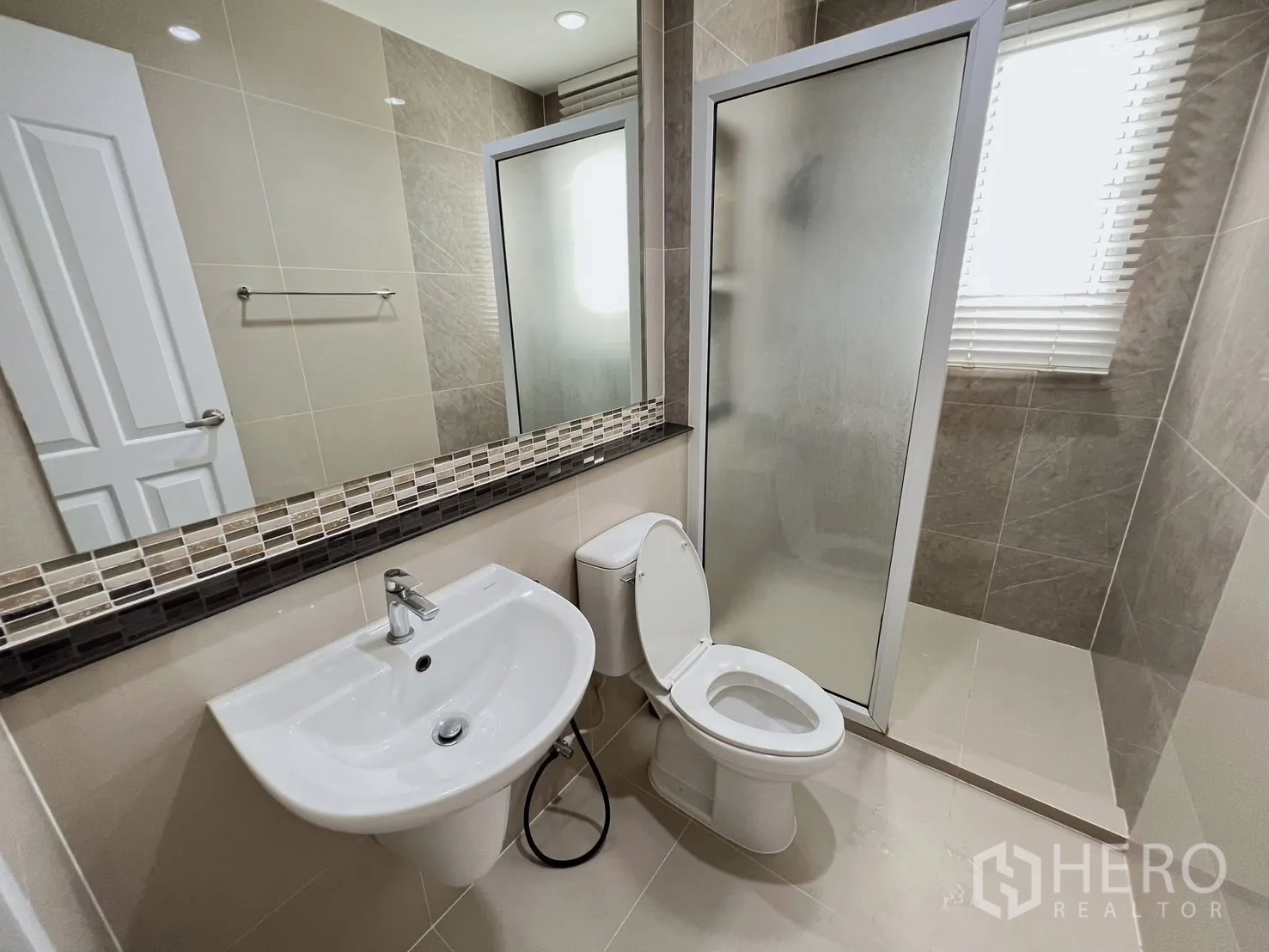 独立式住宅 出租或出售在Khlong Luang, Pathum Thani - 中性色卫生间，玻璃淋浴房、洗手盆与马桶
