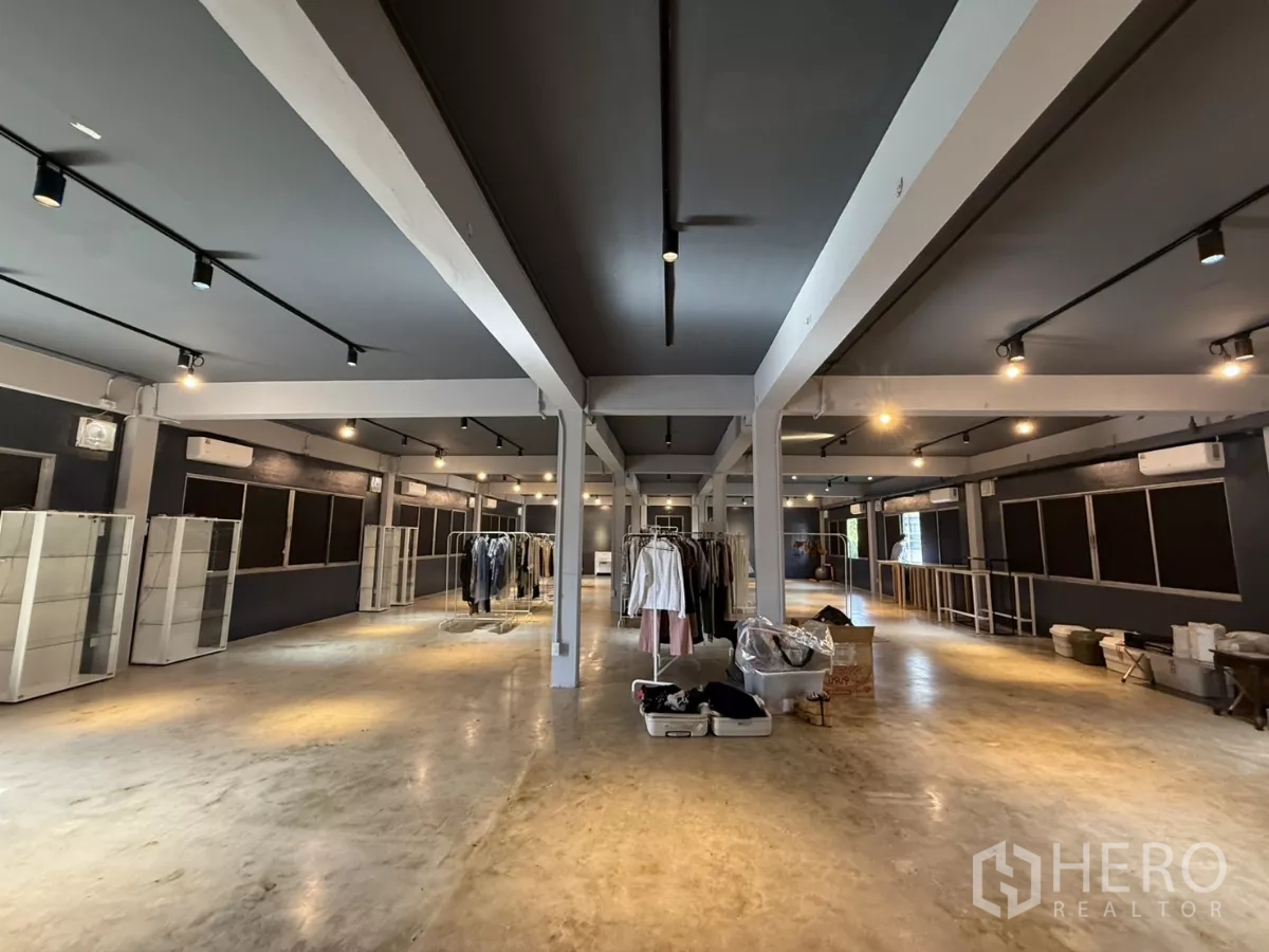 Office Space for rent in Wang Thonglang, Bangkok - Open-plan 300 sqm office with polished concrete floors, dark ceiling, track lighting, support columns and multiple air conditioners in Wang Thonglang, Bangkok.