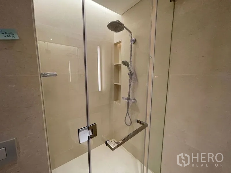 Condominium for rent or sale in Pathum Wan, Bangkok - Glass-enclosed shower with rain head and built-in niches.