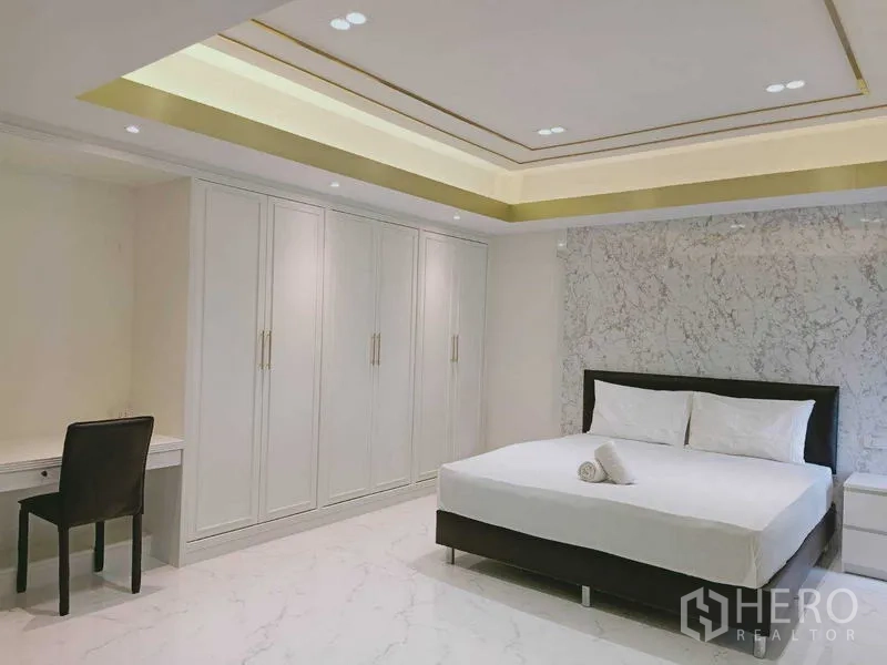 Condominium for  in Watthana, Bangkok - Bedroom with long wardrobe run and study desk.