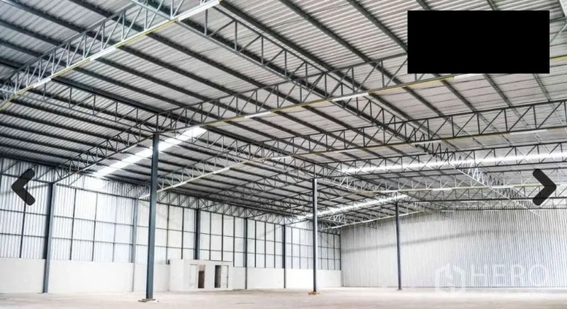 Warehouse for rent in Bang Phli, Samut Prakan - Spacious clear-span warehouse interior with high steel truss roof and skylight panels.