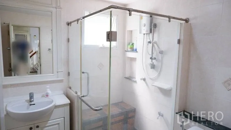 Detached House for rent in Prawet, Bangkok - Bathroom featuring a glass-enclosed shower, small vanity and water heater.