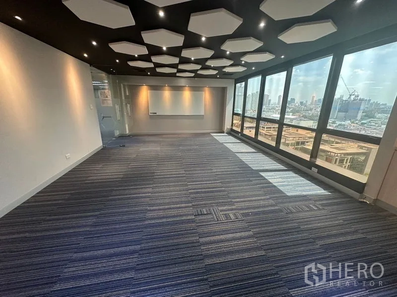 Office Space for rent in Khlong Toei, Bangkok - Conference room with black ceiling and hex acoustic panels facing the skyline.
