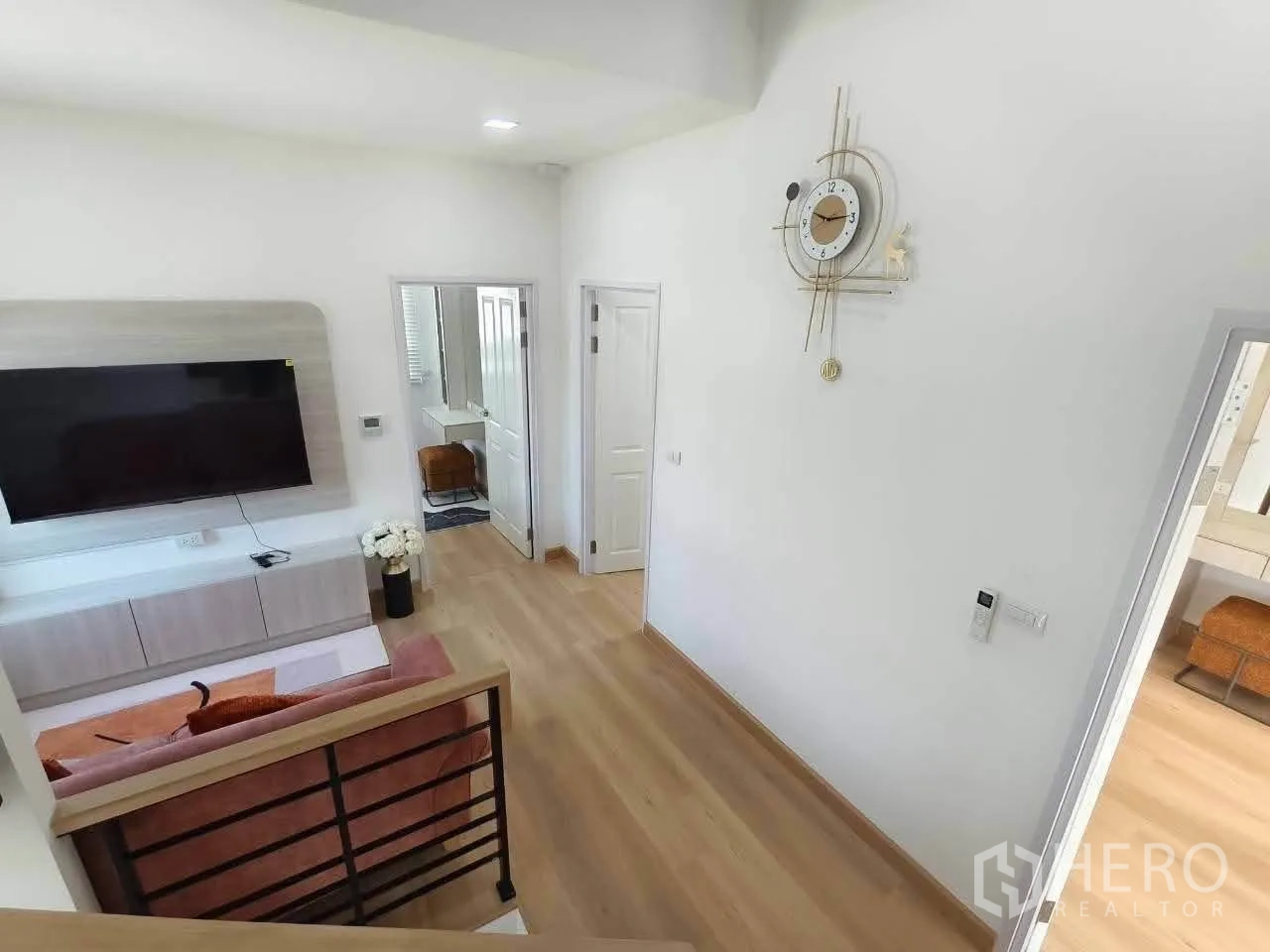 Detached House for rent in Bang Phli, Samut Prakan - Upstairs landing with wall-mounted TV unit, decorative clock, and doors to rooms.