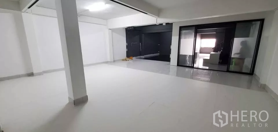 Office Space for rent in Suan Luang, Bangkok - Open workspace view showing white tiled floors, glass partition and ceiling lighting.