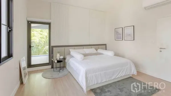 Detached House for rent in Bang Khun Thian, Bangkok - Minimalist master bedroom with king bed, balcony door and garden views.