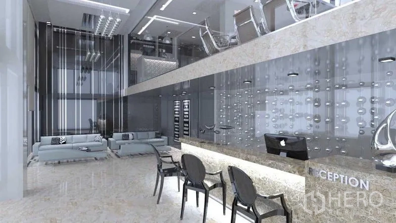 Shophouse for rent in Khlong San, Bangkok - Double-height lobby with reception desk, glass partitions and marble floors in a modern shophouse.