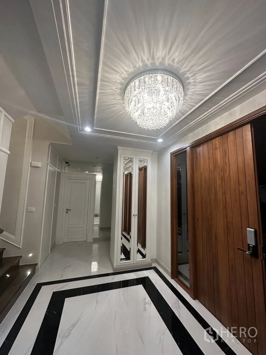 บ้าน ให้เช่าหรือขายในBang Kapi, Bangkok - โถงทางเข้าหรู โคมไฟเพดานคริสตัล พื้นหินอ่อน และประตูไม้
