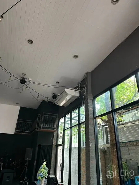 Retail Space for rent in Suan Luang, Bangkok - High ceiling with lighting and air-con units above tall glass windows.