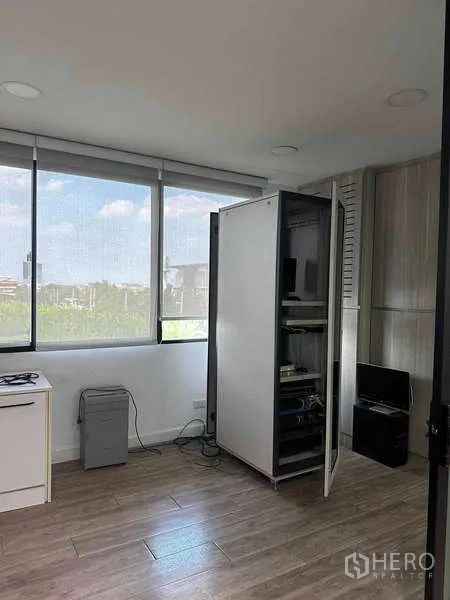 Home Office for rent in Bueng Kum, Bangkok - Server rack and equipment in a dedicated IT room with large windows and city views.