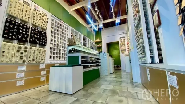 零售空间 出租在Samphanthawong, Bangkok - 店内铺有瓷砖地面，玻璃展柜与墙面陈列架，射灯照明。