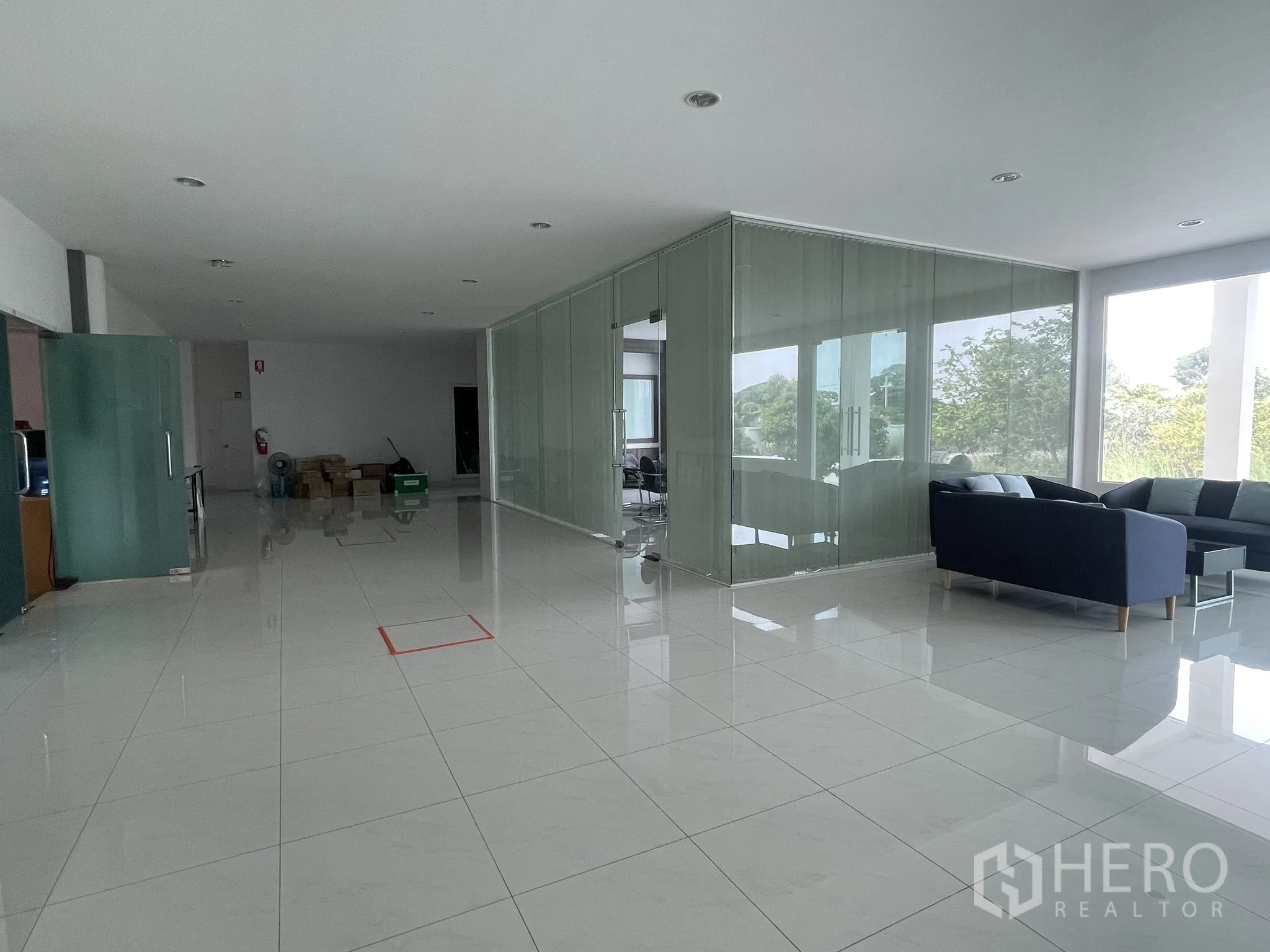 Warehouse for sale in Lat Lum Kaeo, Pathum Thani - Lounge area and glass meeting room inside the office building with garden views.