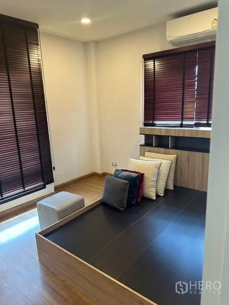 Detached House for rent in Bang Phli, Samut Prakan - Multipurpose room from another angle showing dark blinds and air-conditioner.