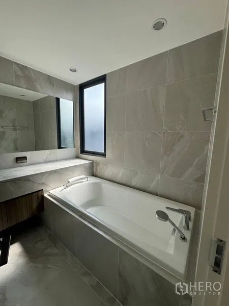 Townhouse for rent - Bathroom with soaking tub, vanity and frosted window for daylight.