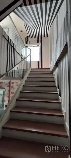 Home Office for sale in Wang Thonglang, Bangkok - Staircase with striped walls and a window bringing natural light.