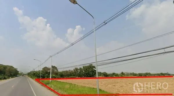 Land for sale in Pathum Thani - Land boundary highlighted in red along a paved road with street lighting and overhead cables.